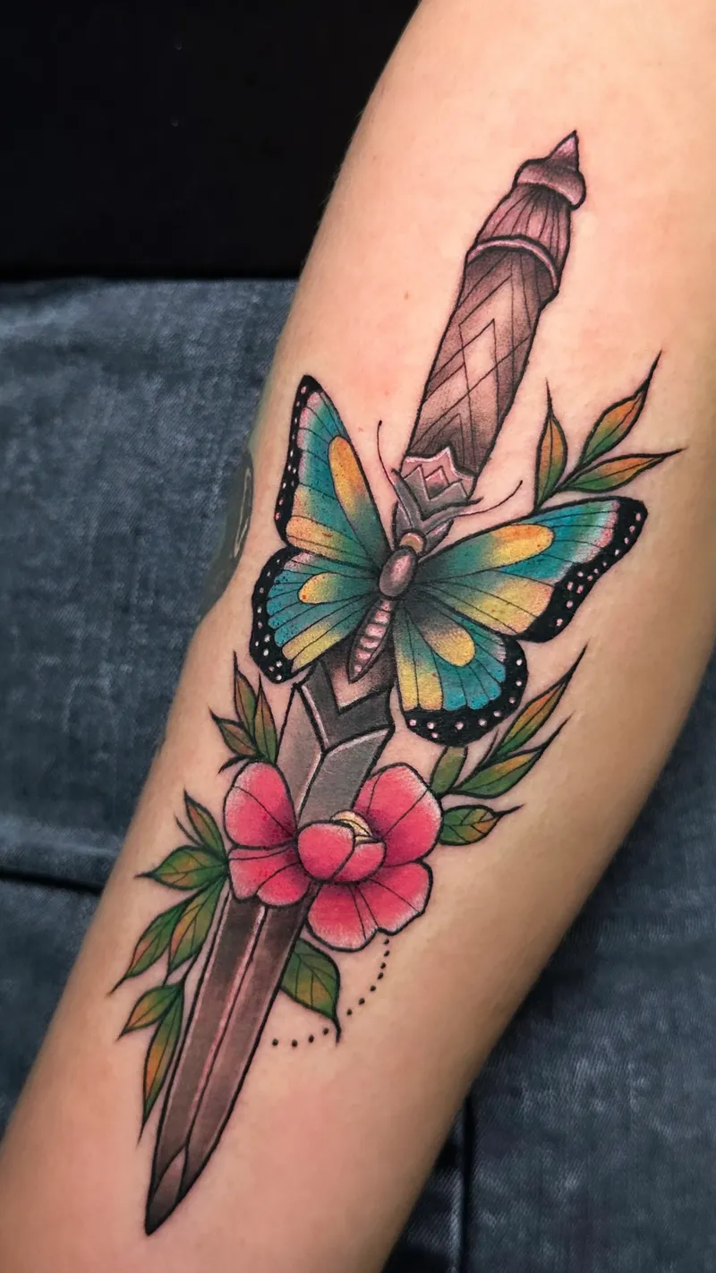 Neo-traditional dagger with a butterfly and pink blossoms on the forearm