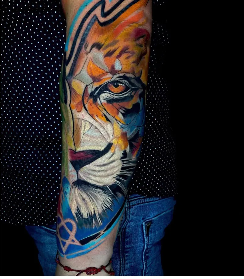 Watercolor tiger tattoo in orange, yellow and blue on the forearm